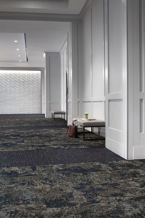Interface Mirano and Bouquet plank carpet tile in open room with white walls and briefcase next to seat imagen número 2