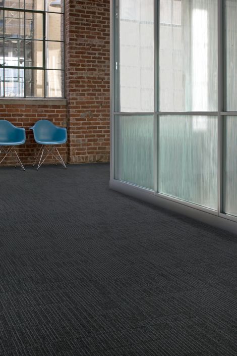 Interface Brescia carpet tile in open space and corridor with two blue chairs