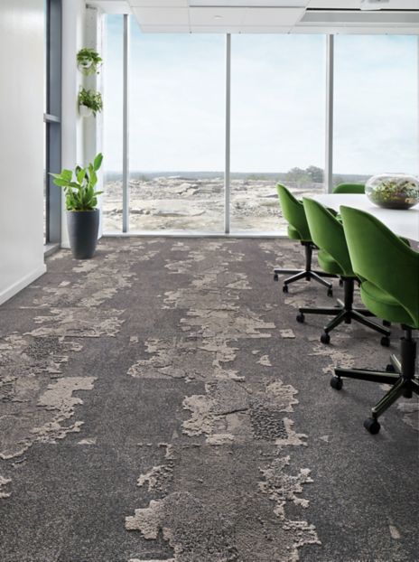 Interface Bridge Creek carpet tile in meeting room with green chairs, plants and large windows