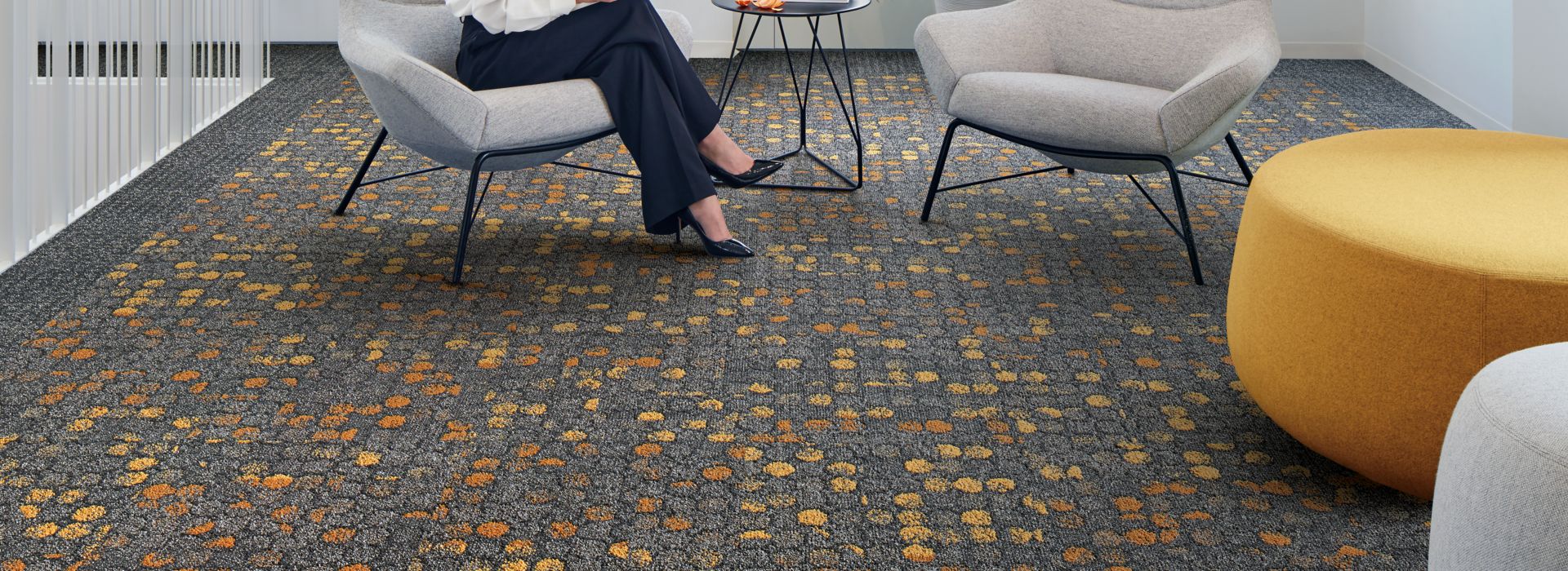 Interface Broome Street and Wheler Street carpet tile in lobby area with woman seated