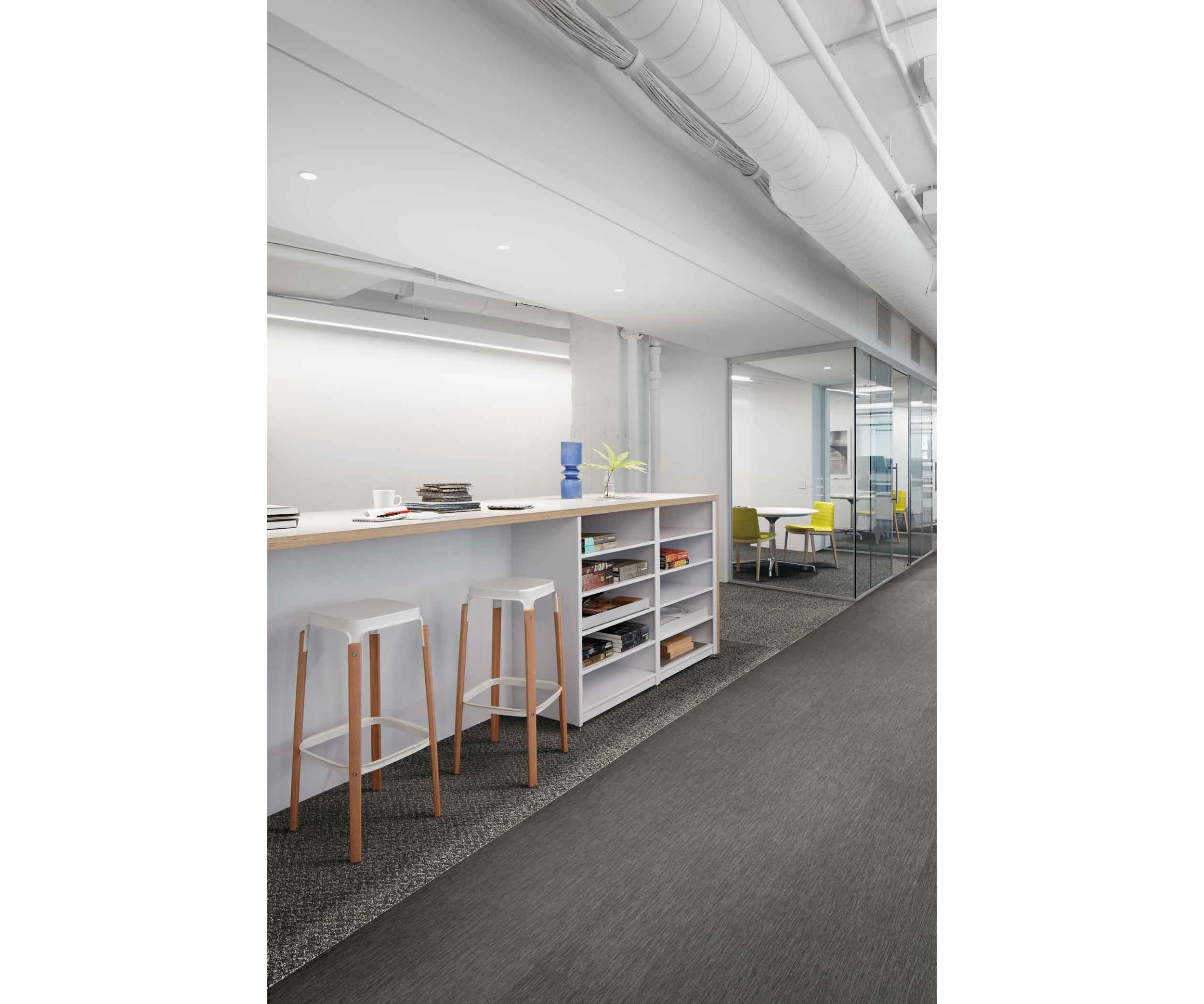 Interface Reade Street carpet tile with Brushed Lines LVT in office corridor with high table, stools and a series of small meeting rooms image number 3