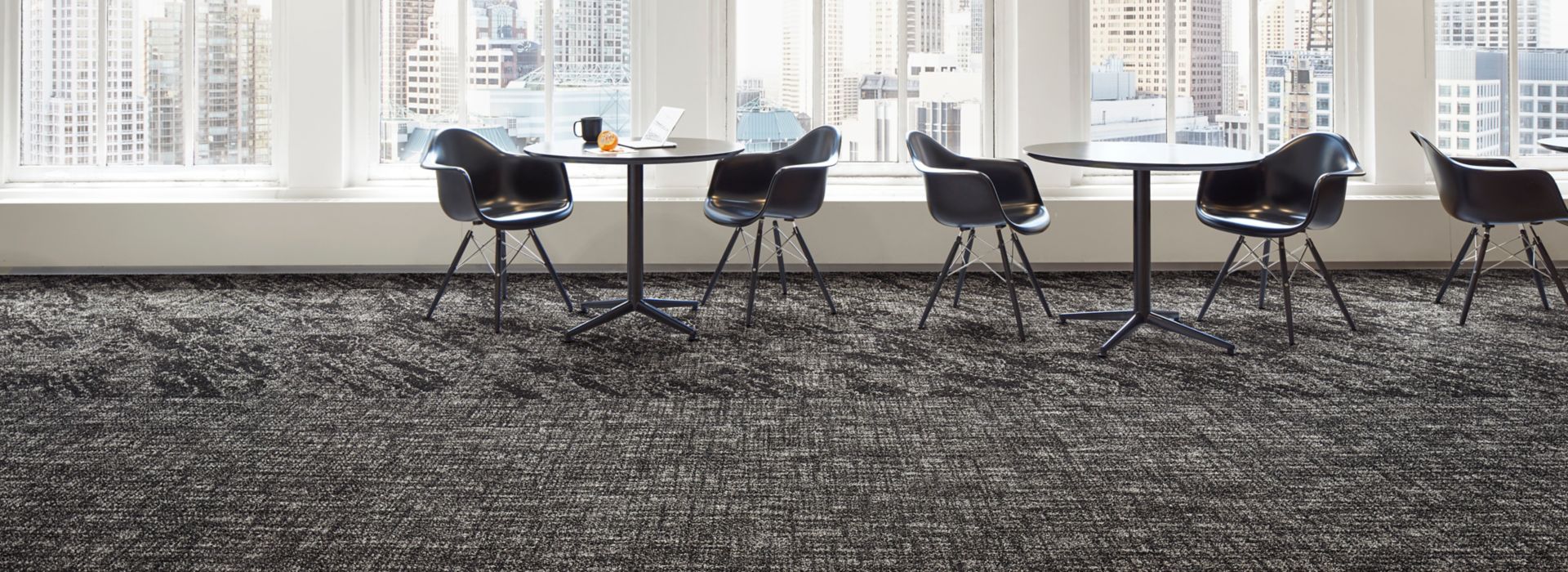 Interface C551 and C552 plank carpet tile in open area with cafe tables and large windows