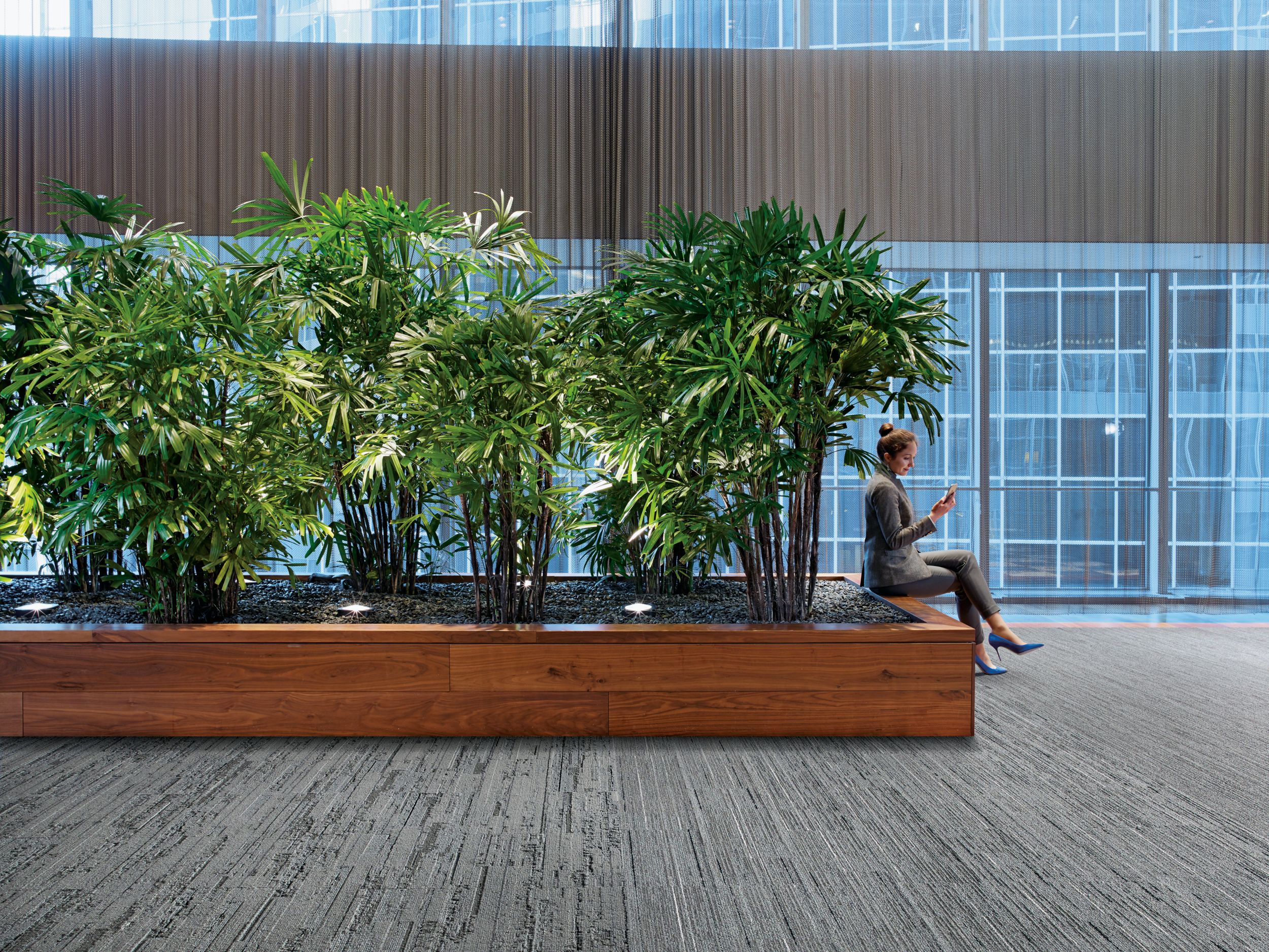 Interface CE171, CE172 and CE173 plank carpet tile in public area with woman seated in front of plants image number 3
