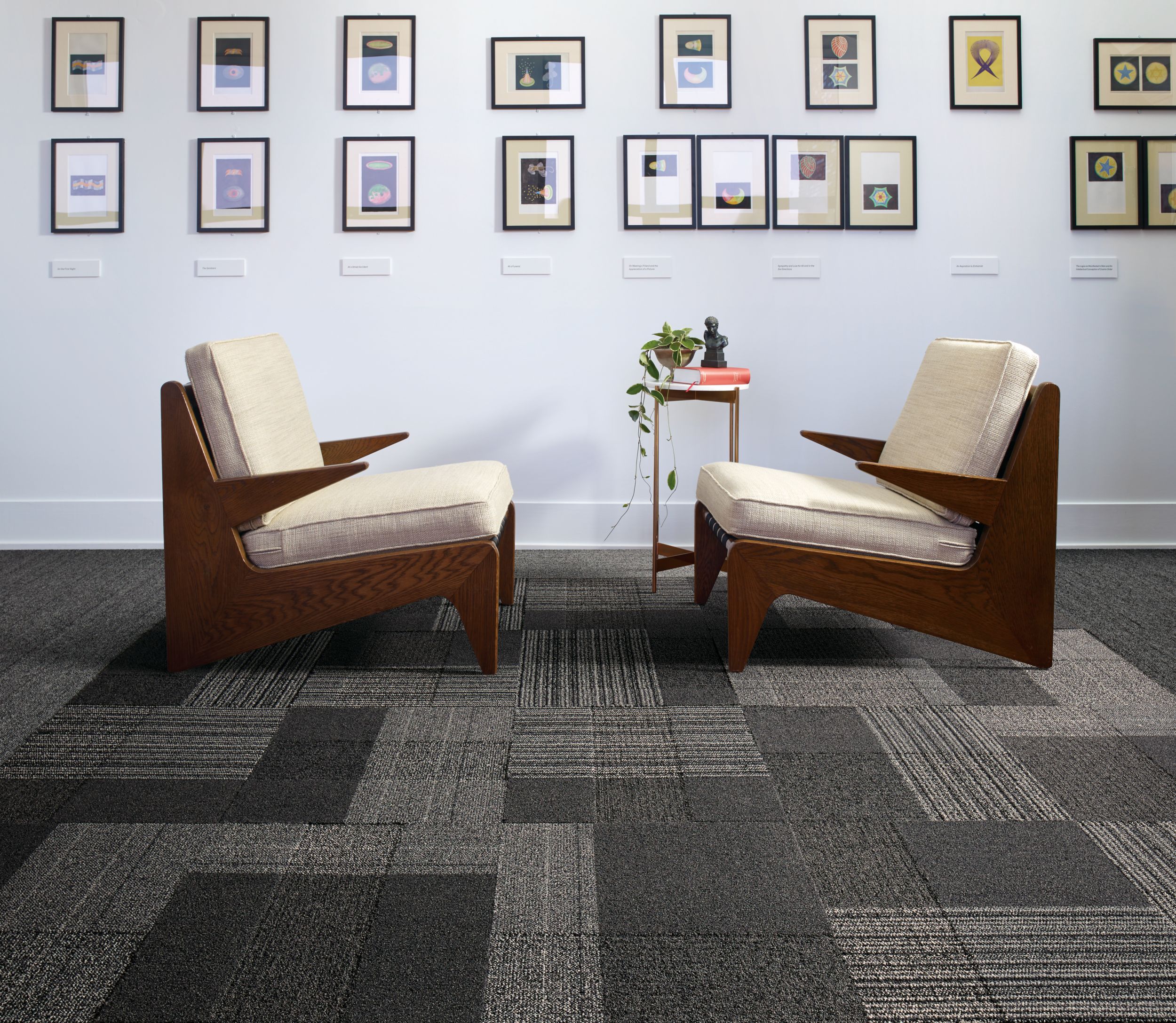 image Interface ShadowBox Velour carpet tile and WW860 plank carpet tile in seating area with two chairs and a lot of small prints on the wall numéro 2
