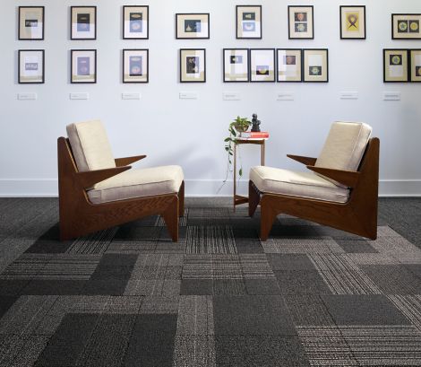 Interface ShadowBox Velour carpet tile and WW860 plank carpet tile in seating area with two chairs and a lot of small prints on the wall image number 6