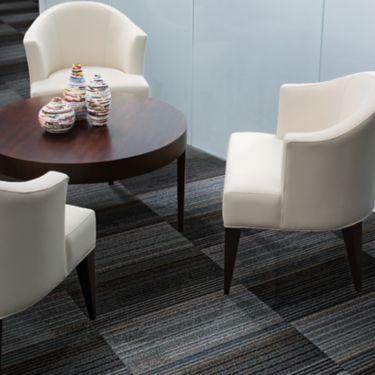 Interface Chenille Warp carpet tile in seating area with table and three chairs image number 1