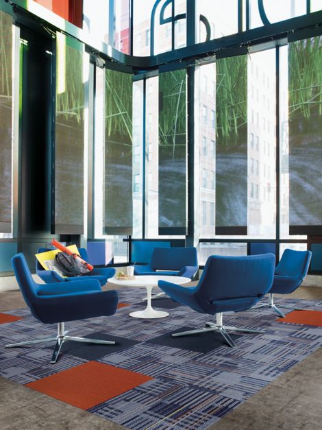 Interface Cordoba Colores and Viva Colores carpet tile and Textured Stones LVT in seating area with bright blue chairs