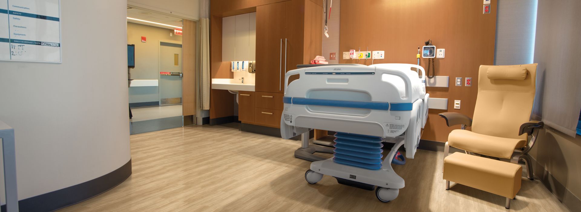 Interface Criterion Classic Woodgrains LVT in patient room with hospital bed and chair