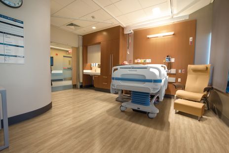 Interface Criterion Classic Woodgrains LVT in patient room with hospital bed and chair