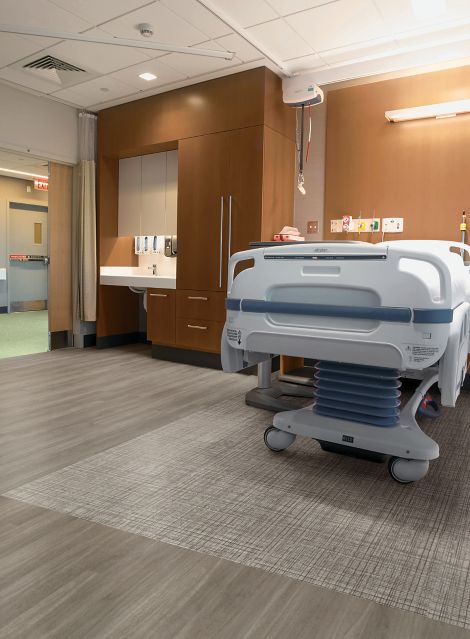 Interface Criterion Classic Woodgrains and Criterion Classic Wovens LVT in patient room with hospital bed 