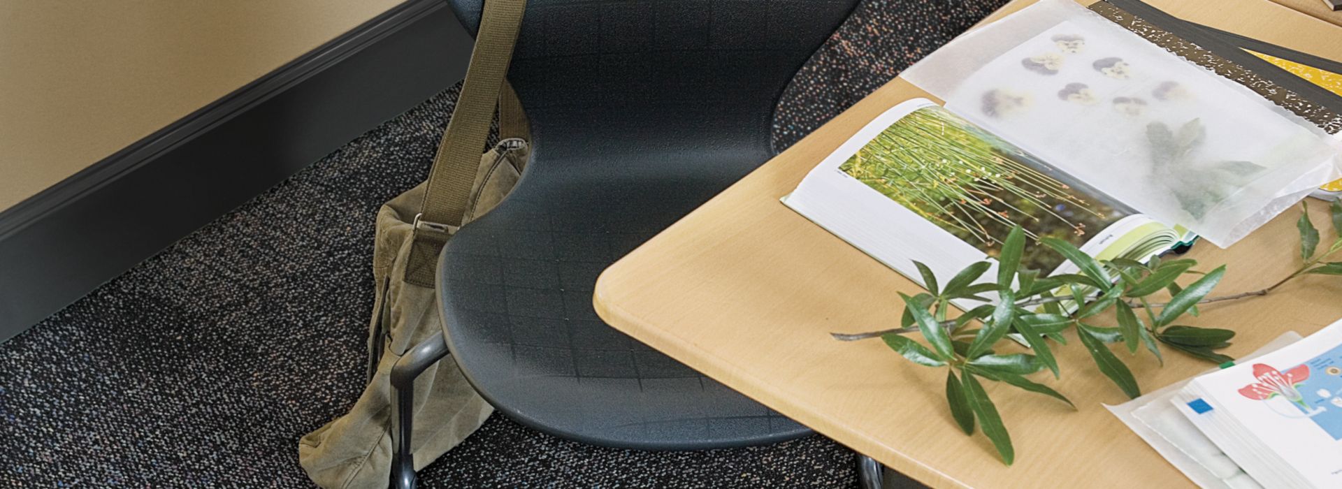 Top down view of Interface Cubic Colours carpet tile in classroom with desk