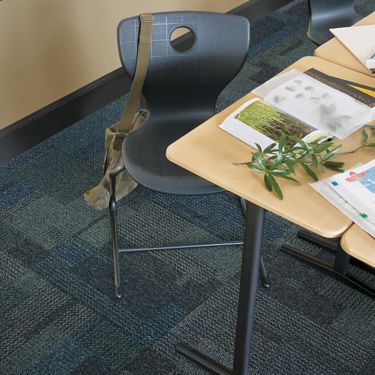 Top down view of Interface Cubic carpet tile in classroom with desk image number 1