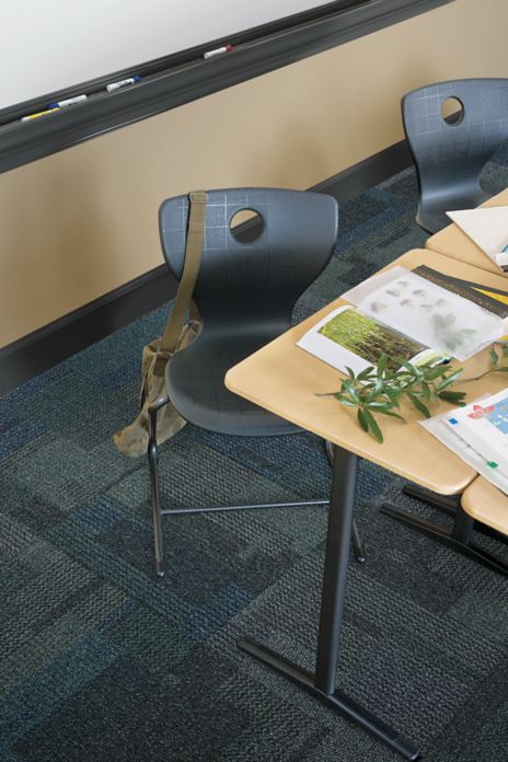 Top down view of Interface Cubic carpet tile in classroom with desk