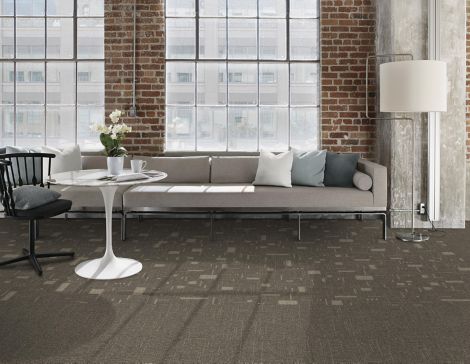Interface DL902 and DL903 carpet tile in public space with white couch and exposed brick wall imagen número 4