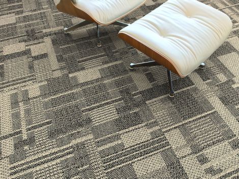 Detail of Interface DL923 carpet tile with Eames chair and ottoman