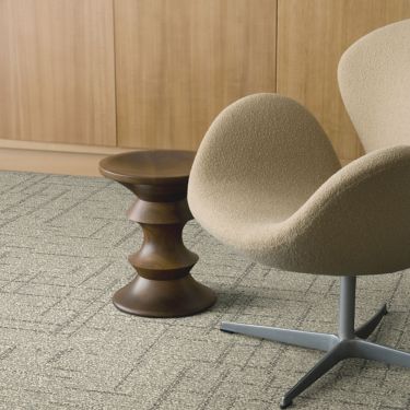 Interface DL925 carpet tile with chair and wood side table