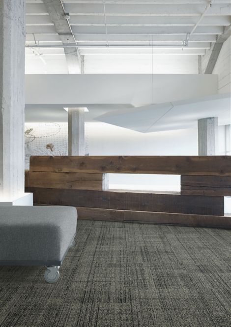 Interface DL926N carpet tile in open area with wood accent wall