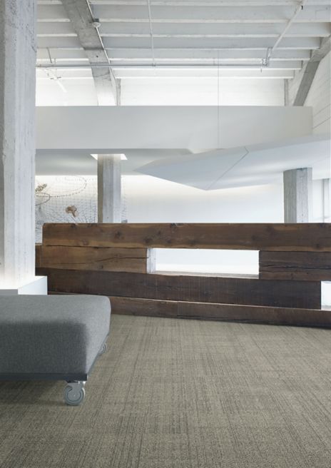 Interface DL926N carpet tile in open area with wood accent wall