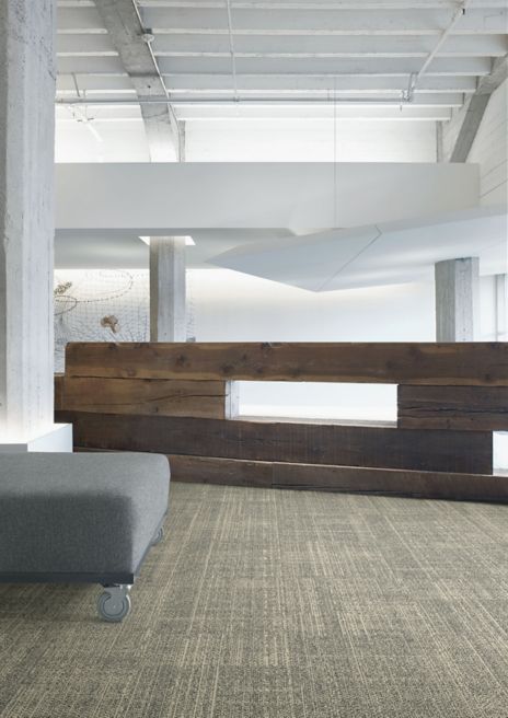 Interface DL926 carpet tile in open area with wood accent wall