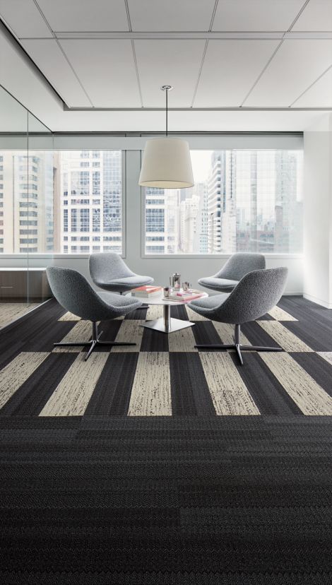 Interface Darning and Stitchery plank carpet tile in open lounge area with table and four chairs