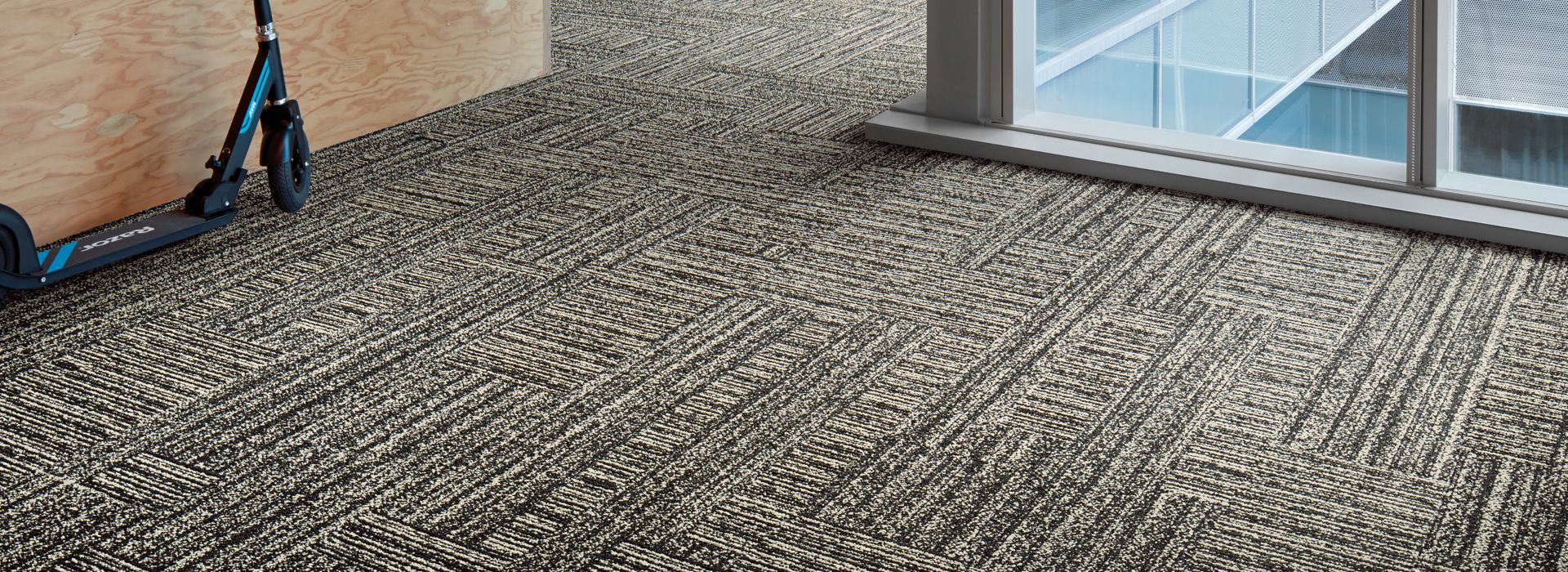 Interface Decibel and Hard Drive plank carpet tile in small area with glass windows
