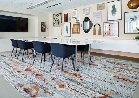 Interface Shantung plank LVT and Desert Ranch plank carpet tile in meeting room with big screen TV and artwork on walls image number 5