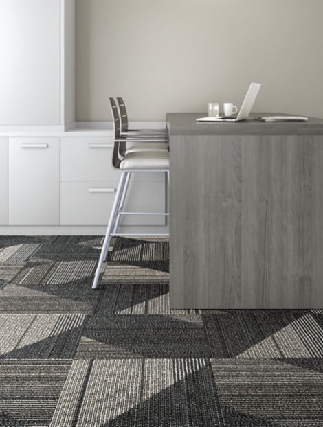 Interface Detours Ahead carpet tile in seating area with desk and two chairs