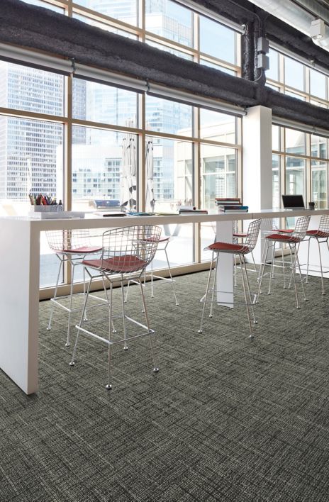 Interface Diminuendo plank carpet tile in seating area with glass windows