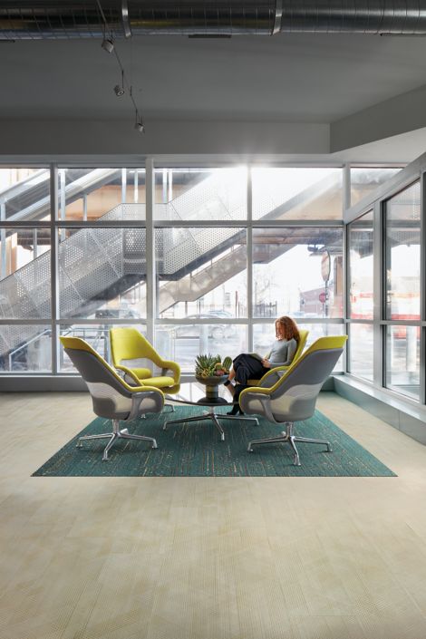 Interface Drawn Lines LVT and Circuit Board plank carpet tile in office comon area with oversized chairs