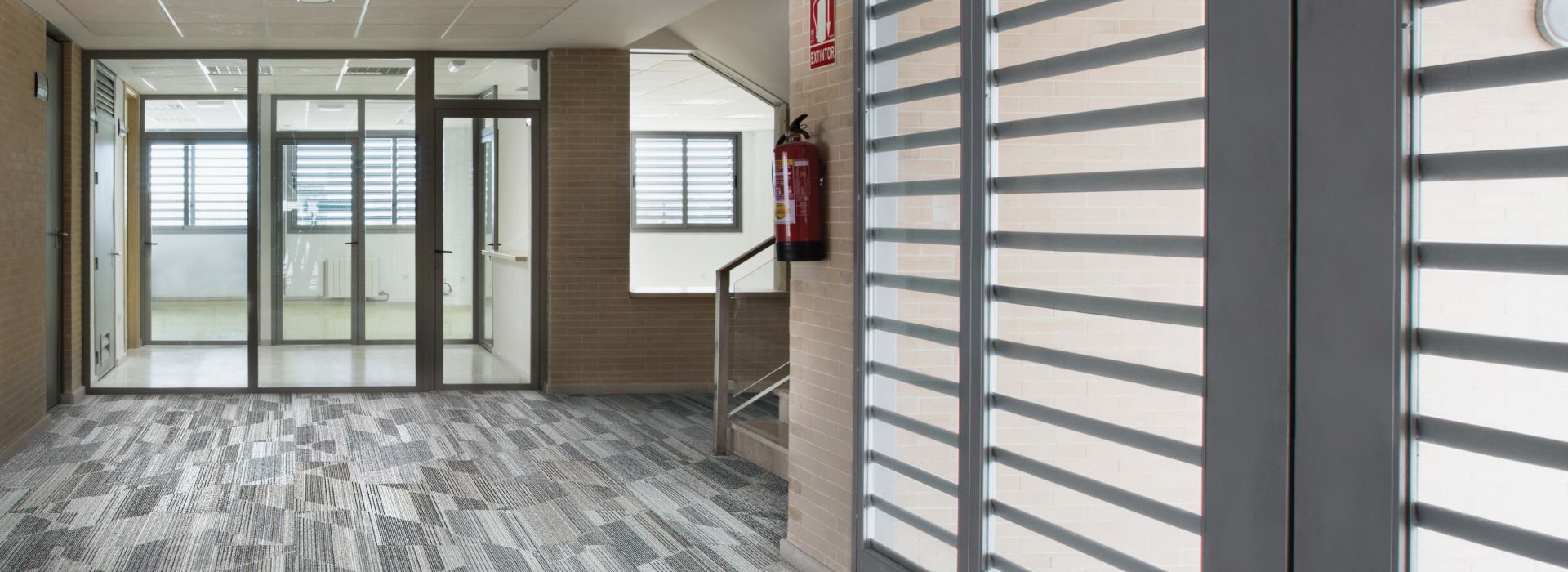 Interface Driftwood plank carpet tile in open area of corridor