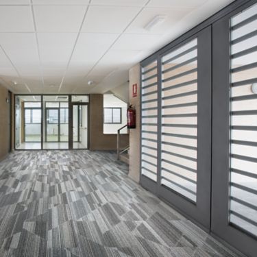 Interface Driftwood plank carpet tile in open area of corridor
