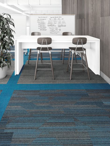Interface Driftwood and SL910 plank carpet tiles in small meeting area with white table and four stools