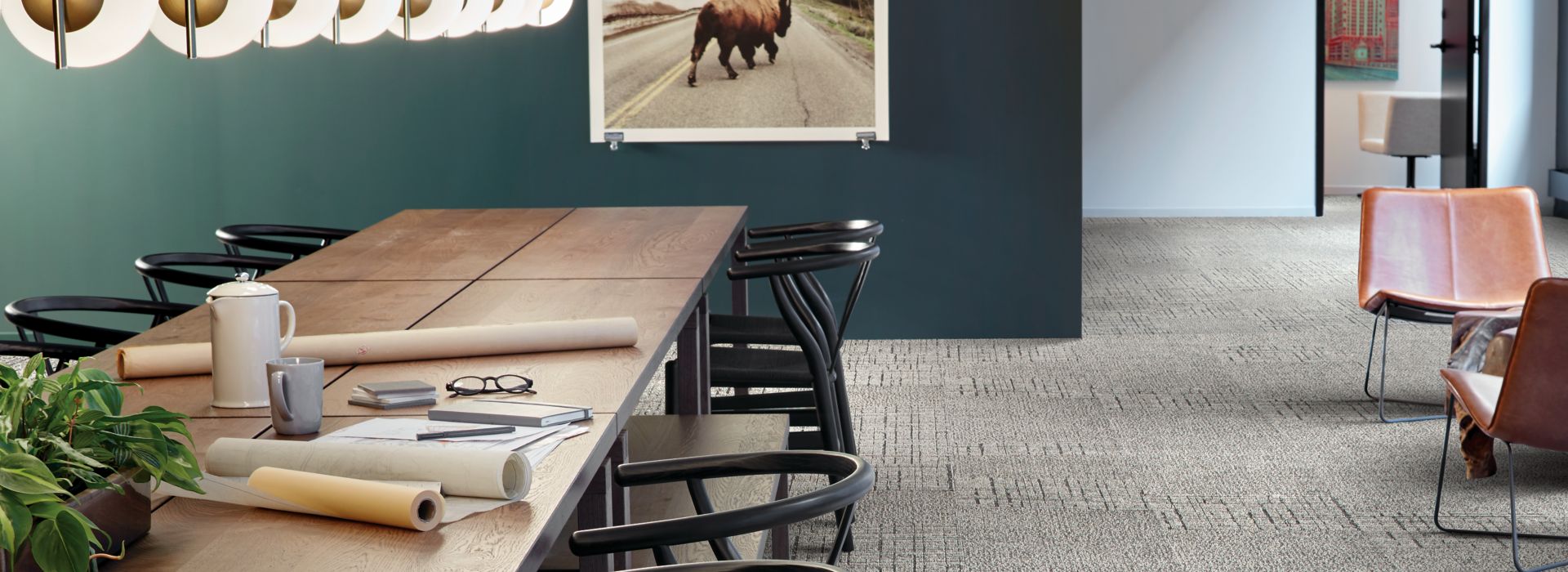 Interface Duplex and Sublet carpet tile in large seating area with long table surrounded by chairs