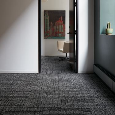 Interface Duplex carpet tile in small room with doorway leading to other room