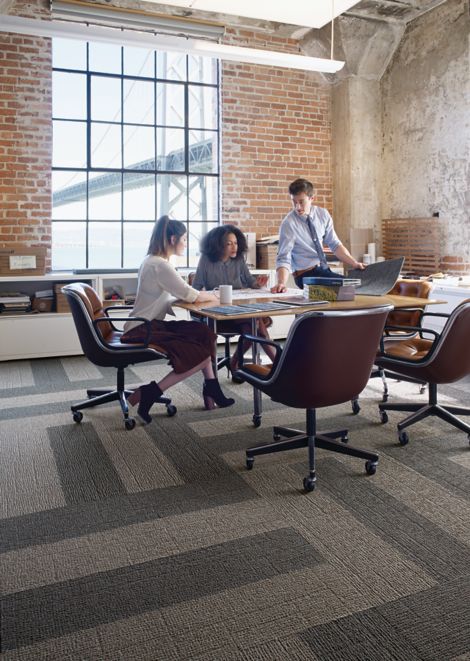 Interface EM551 plank carpet tile in open room with people meeting around wood table