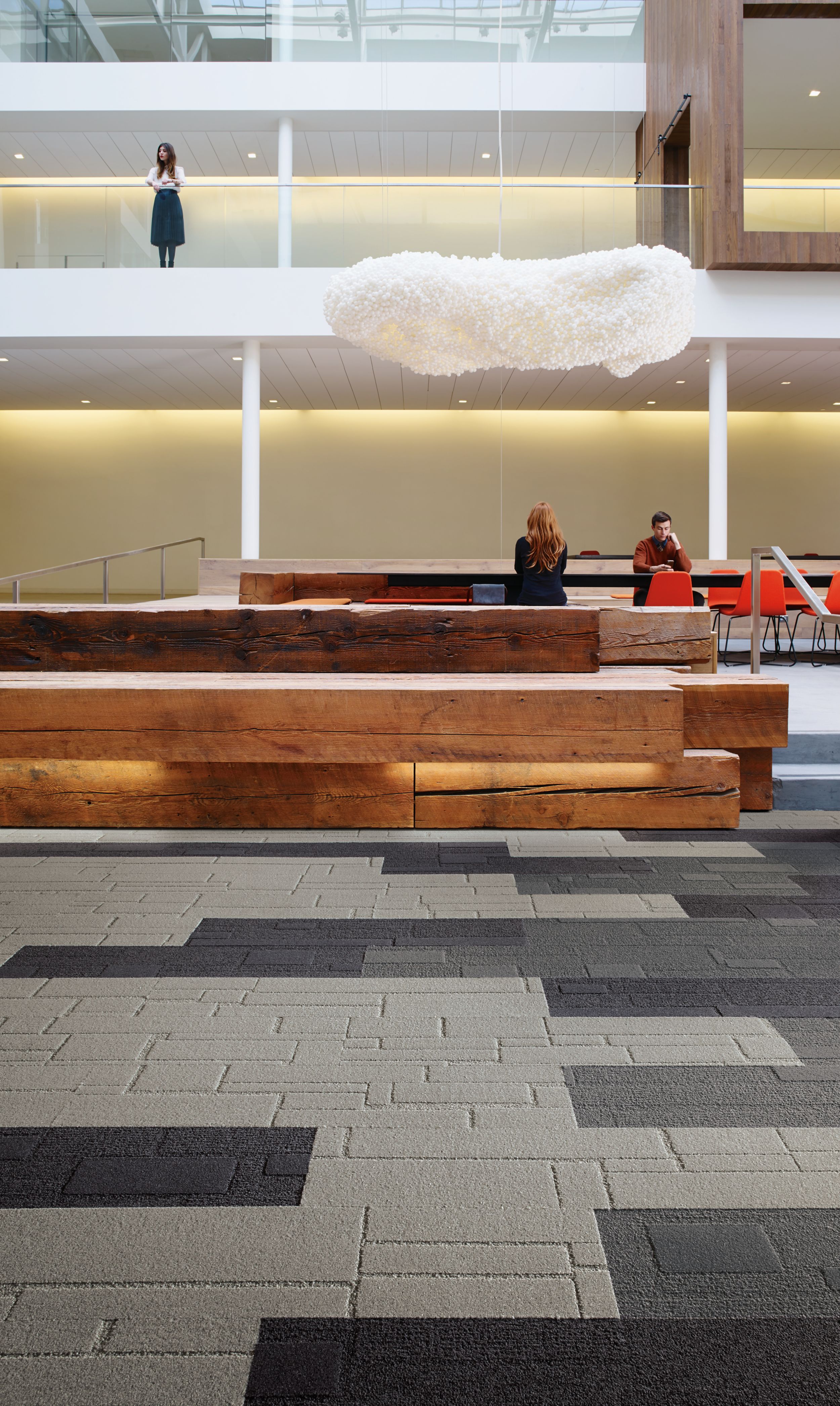 Interface EM551 and EM553 plank carpet tile in modern open lobby with man and woman working at table image number 10