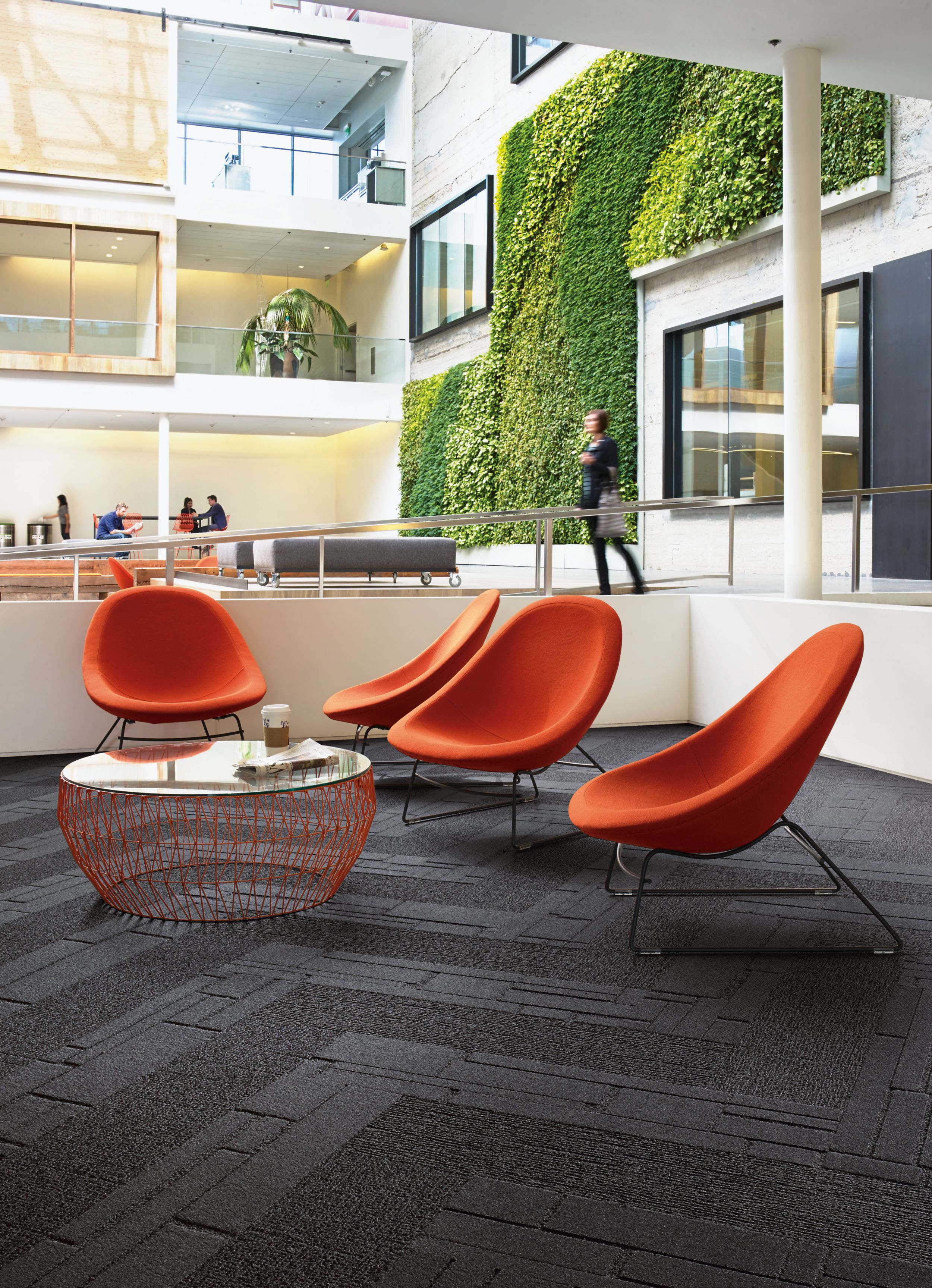 Interface EM551 and EM553 plank carpet tiles in indoor open area with vine wall image number 12
