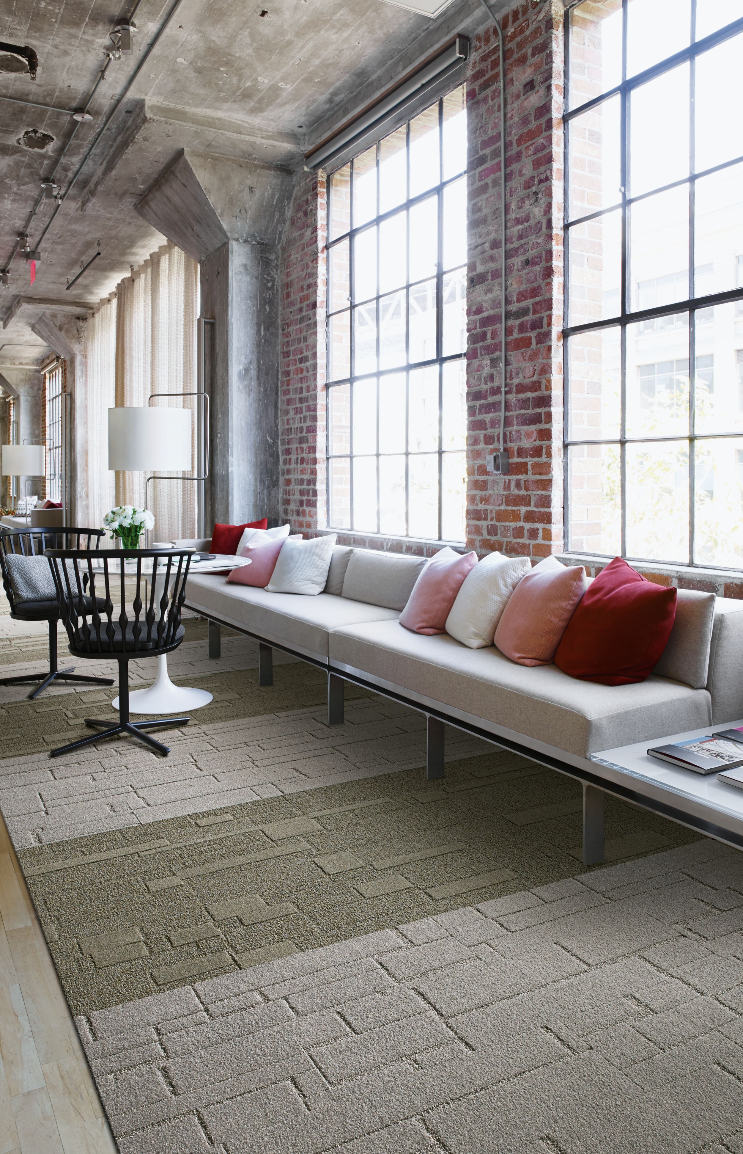 Interface EM552 and EM553 plank carpet tile in open area with brick wall and white couches imagen número 6