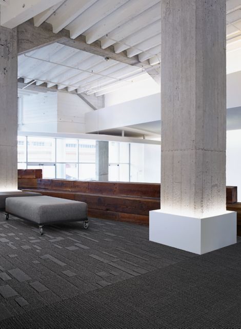 Interface EM552 plank carpet tile in open waiting room with granite column and railroad tie bench image number 12