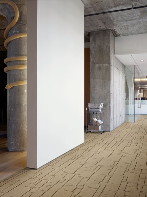 Interface EM553 plank carpet tile in entryway with cement column with snake wrapping around