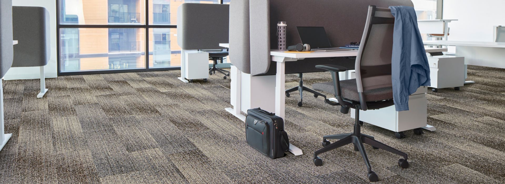 Interface Effervescent plank carpet tile in open office with glass wall