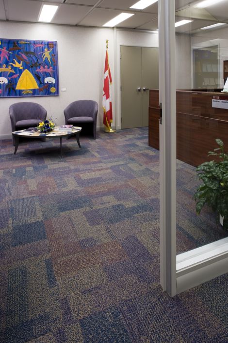 Interface Entropy carpet tile in government building front desk with Canadian flag in background