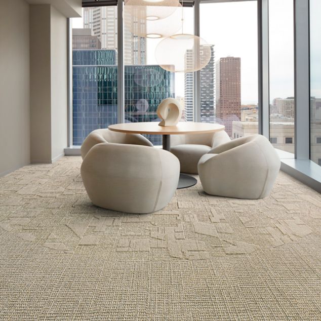Interface E612 and E613 plank carpet tile in corporate small meeting area with wood table and sculpture