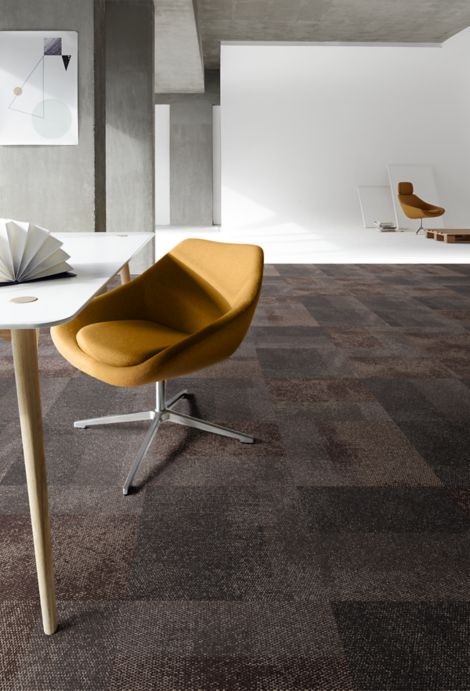 Interface Exposed carpet tile in studio with white room and wooden palette in background