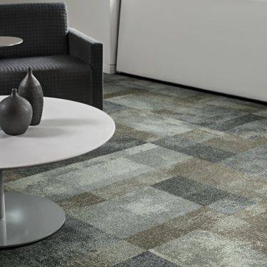 Interface Exposed carpet tile in waiting area with white table and black chair with pottery on table image number 1