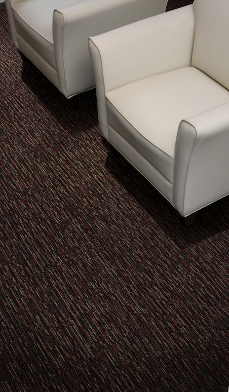 Detail of Interface Farmland carpet tile with white chairs