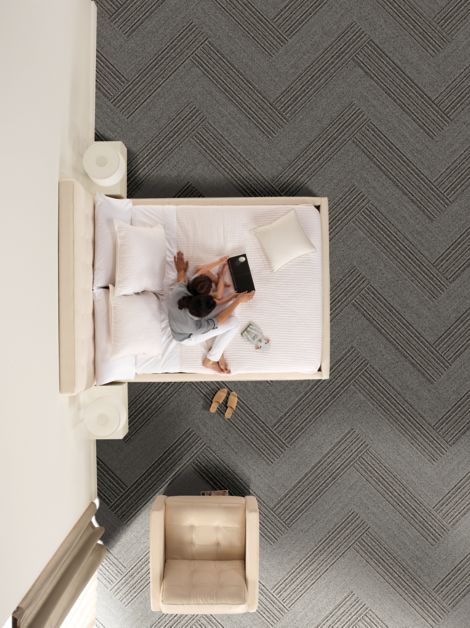 Interface WW860 and WW865 plank carpet tile in hotel guest room with woman and child on bed image number 9