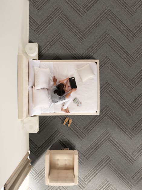 Interface WW860 and WW865 plank carpet tile in hotel guest room with woman and child on bed image number 5