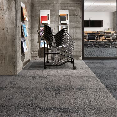 Interface Flagstone carpet tile with stack of chairs