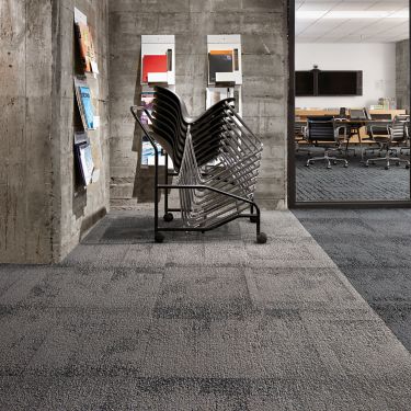 Interface Flagstone carpet tile with stack of chairs imagen número 1